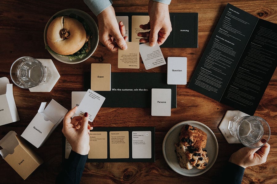People playing the Laminex sales card game