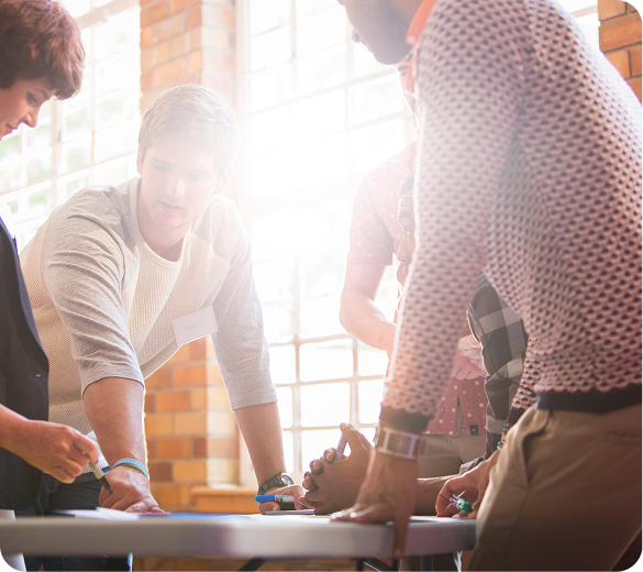 Team gathered around a table in a sunlit office