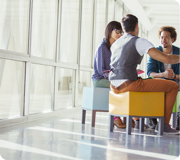 Colleagues in conversation in a bright meeting space