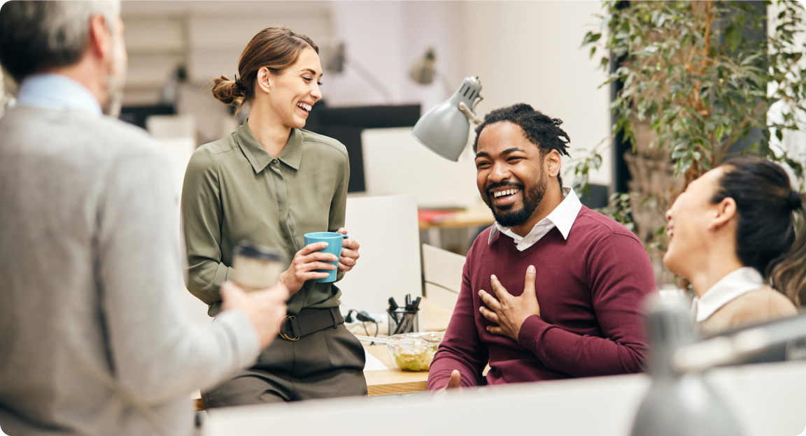 Colleagues laughing together in a meeting