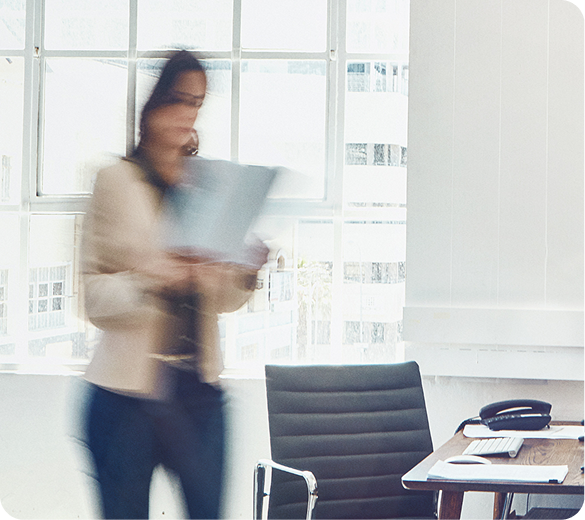 Professional walking through a bright office
